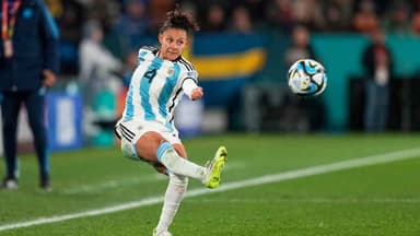 Three women walk from Argentinian football team